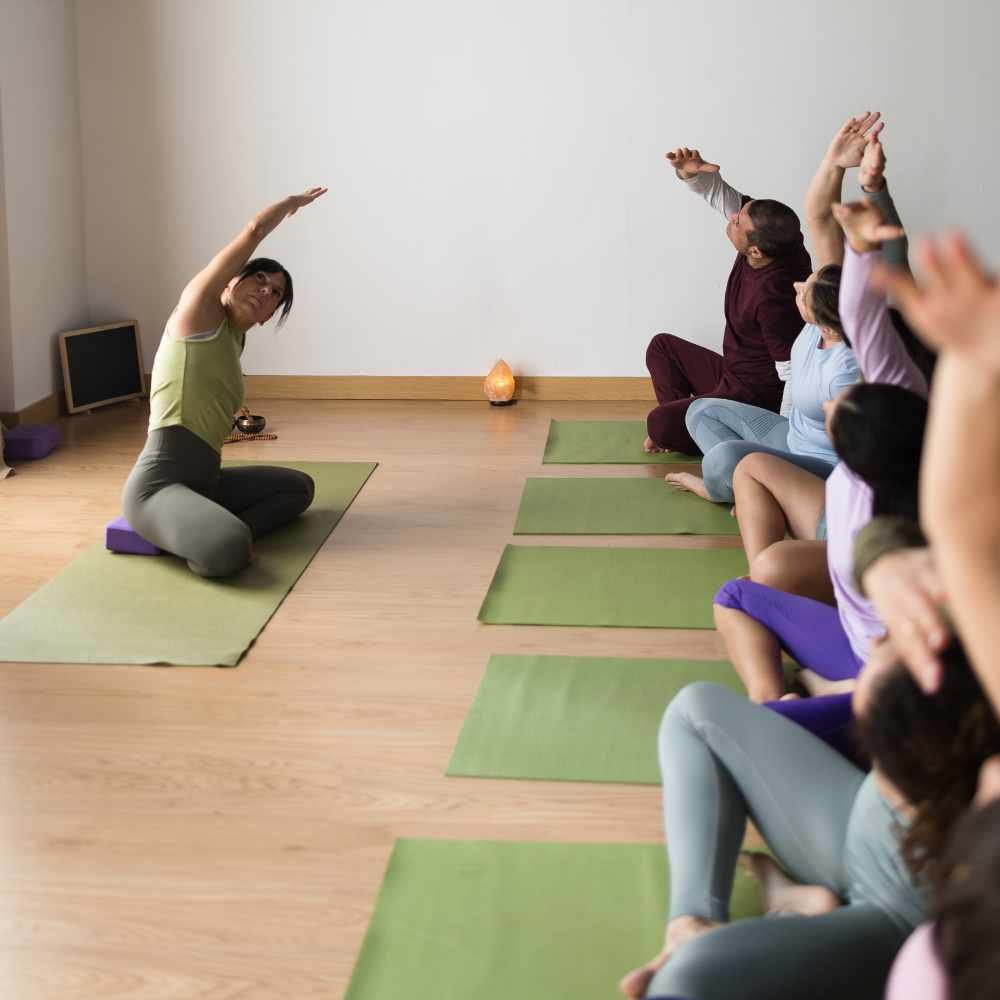 adults-practicing-side-bend-pose-during-yoga-class-EP5DGFF.jpg
